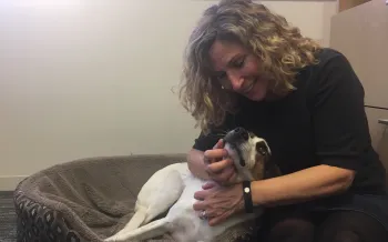 Humane World for Animals CEO Kitty Block cuddles with a dog.