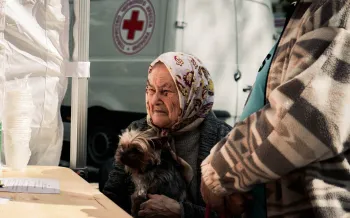 A woman receives aid for her dog