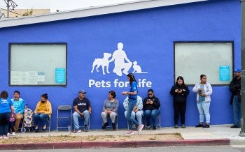 People waiting in line outside for Pets For Life services.