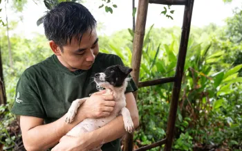 A man holding a dog