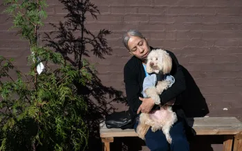 Woman holding a dog outside