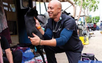 Carrying a backpack filled with basic veterinary supplies, Dr. Kwane Stewart examines the pets of people experiencing homelessness.