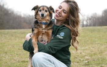 Staff holding puppy