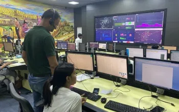 Manish Pande, a coordinator with the Lucknow community engagement team, attends a call in the control room, during a training for the program. 