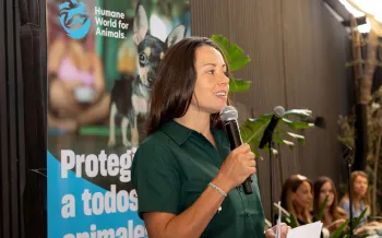 A woman in Chile talking into a microphone at an event