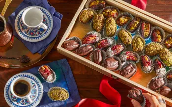 Photo from above of vegan stuffed dates displayed in a wooden box.