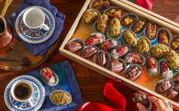Photo from above of vegan stuffed dates displayed in a wooden box.