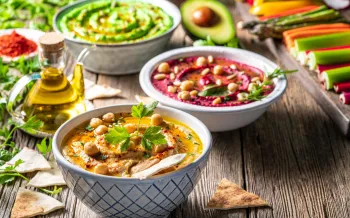 Various vegan dishes set on a table with other vegetables