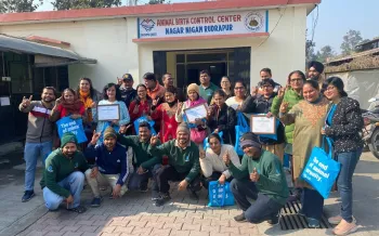 a group of people posing for a photo outside of a building