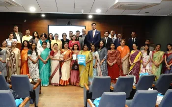 A group of people pose in an auditorium