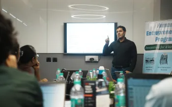 Conference room where a group of people are engaged in a presentation.