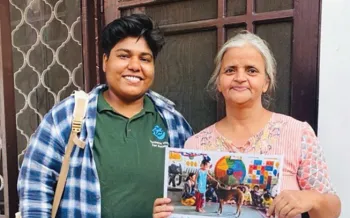Animal welfare advocate and resident holding an educational poster outside a home.