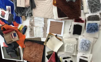A tabletop covered with an assortment of textile and material swatches.